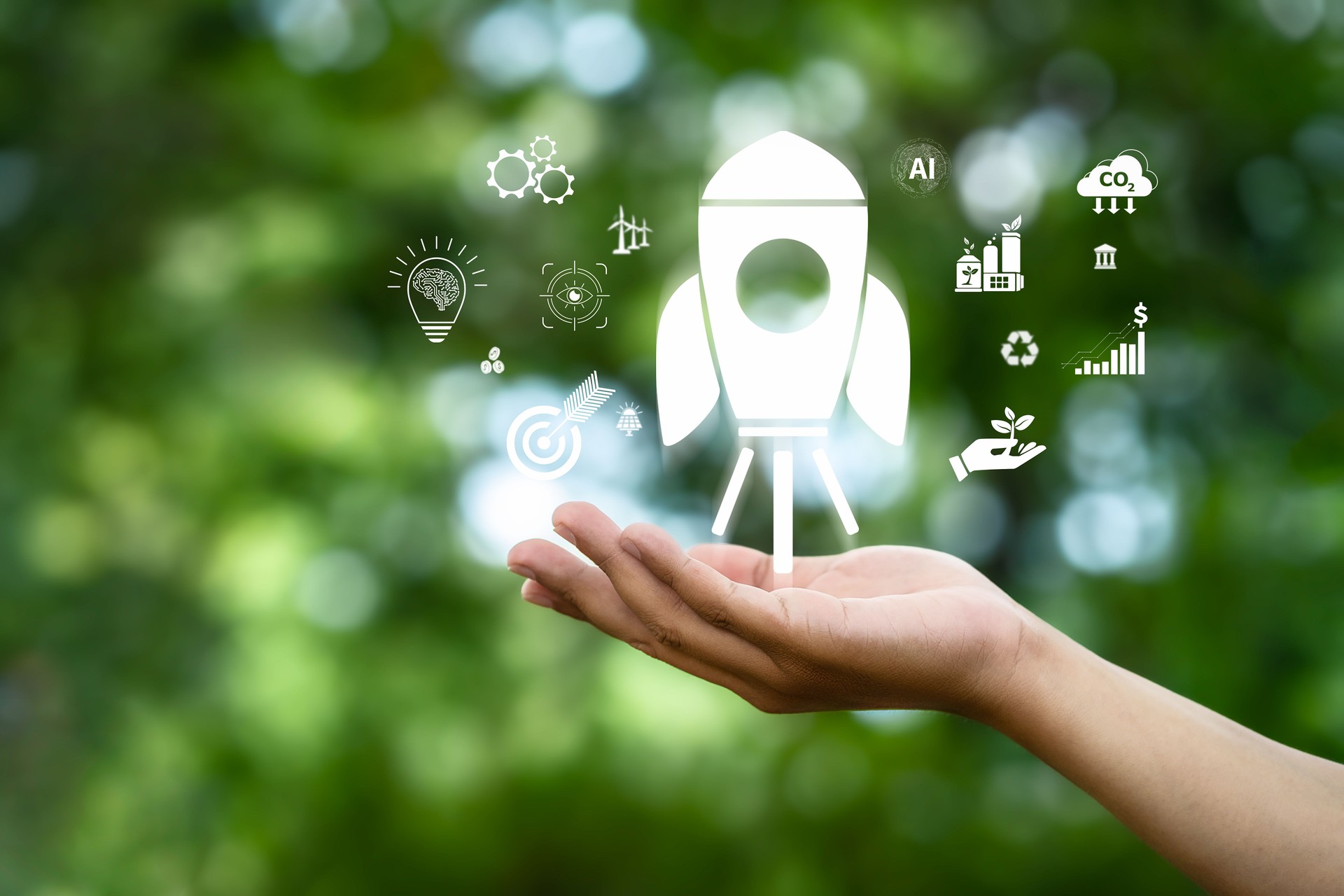 Hand with rocket icon and environment on green background, representing vision of organization focusing on sustainability, finance, investment to achieve goals such as ESG, Net Zero, SDGs, etc.
